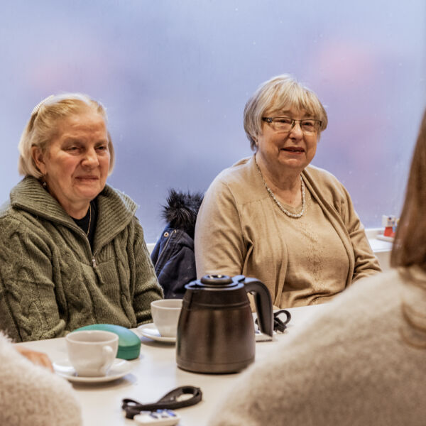 Senioren in gesprek met audiologe over hoorhulpmiddelen